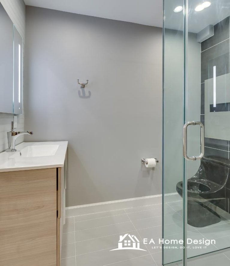 A modern farmhouse bathroom with a rustic wood double vanity, black fixtures, oval mirrors, and a glass shower stall.