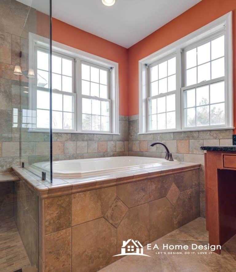 Spacious bathroom with a large glass-enclosed shower, soaking tub, and abundant natural light from multiple windows.