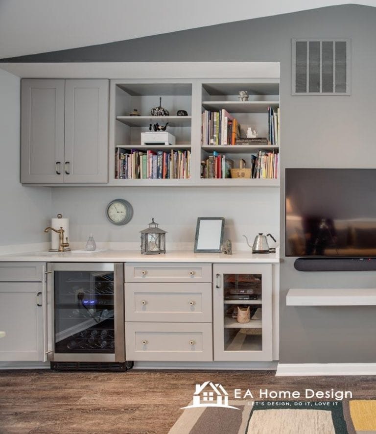 Modern built-in home bar with cabinetry, wine fridge, and decorative shelves for stylish living.