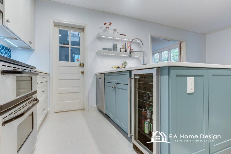 Modern kitchen renovation featuring quartz countertops, a large benchtop with chairs, pendant and recessed lighting, sleek flooring, and premium appliances with coordinated wall paint.