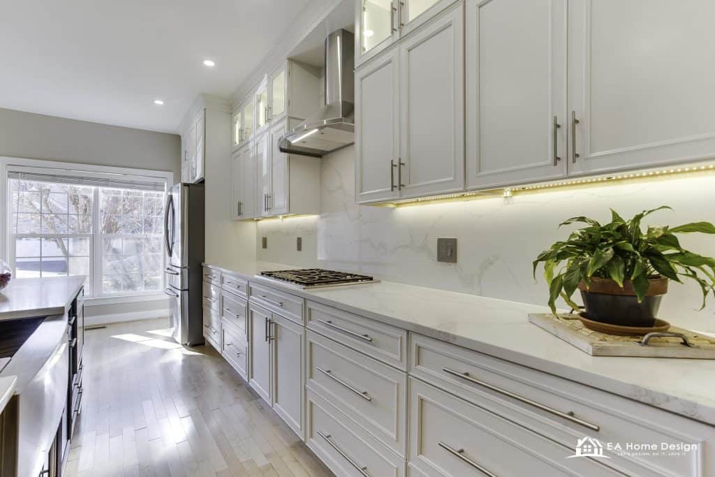 Modern kitchen with marble island, wood cabinets, and built-in appliances