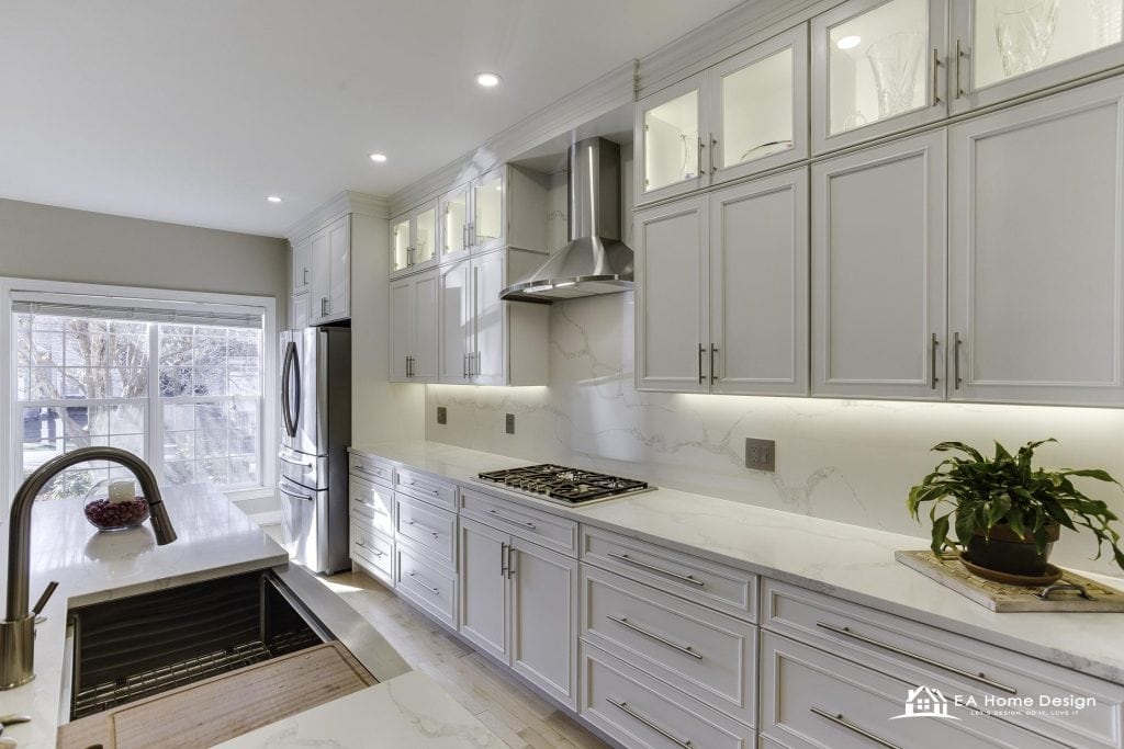 Modern kitchen with marble island, wood cabinets, and built-in appliances