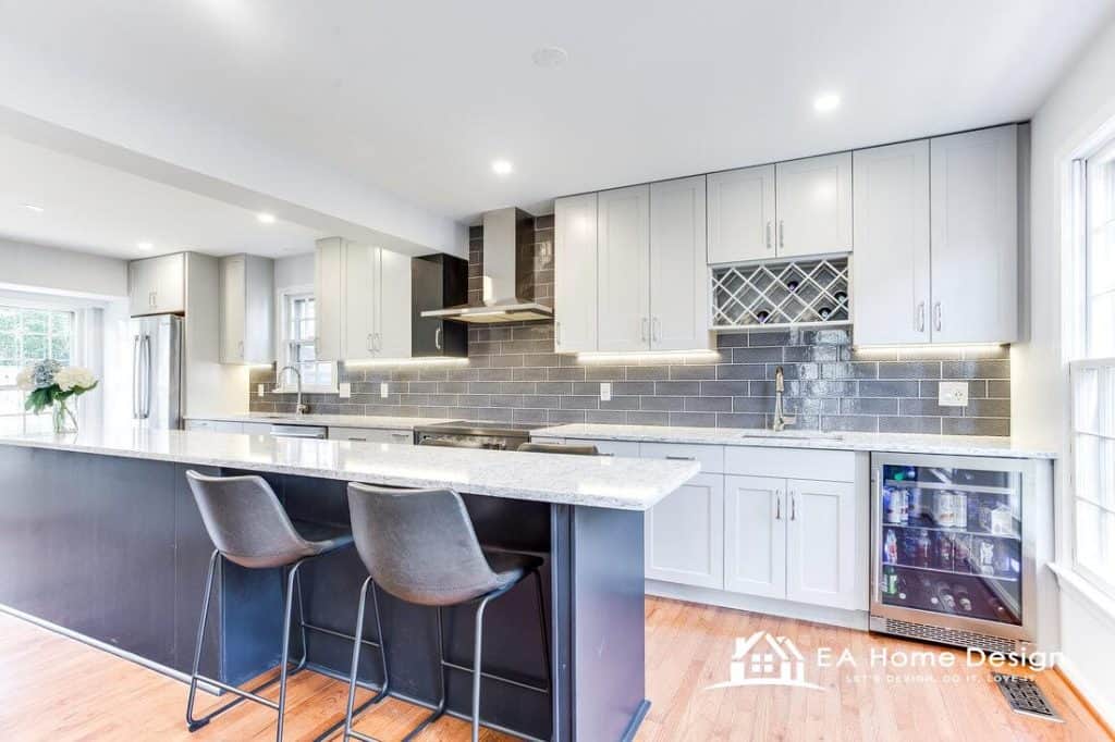 Modern kitchen with white cabinets, gray subway tile backsplash, and granite countertops for stylish home design