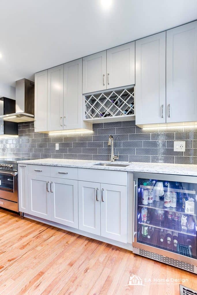 Modern kitchen design with white cabinets, marble countertops, and stylish bar seating for open-concept living