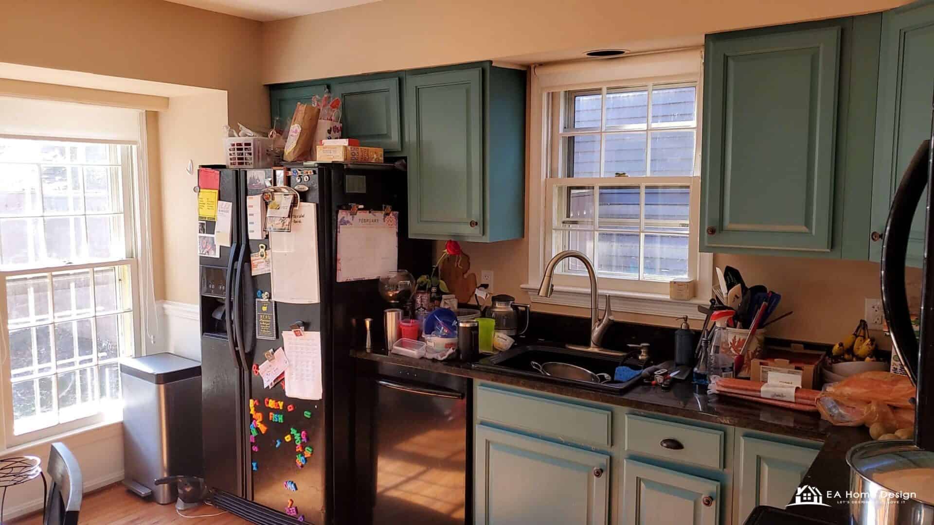 Before photo of a closed galley kitchen in Reston with teal cabinets, black refrigerator and narrow walkway