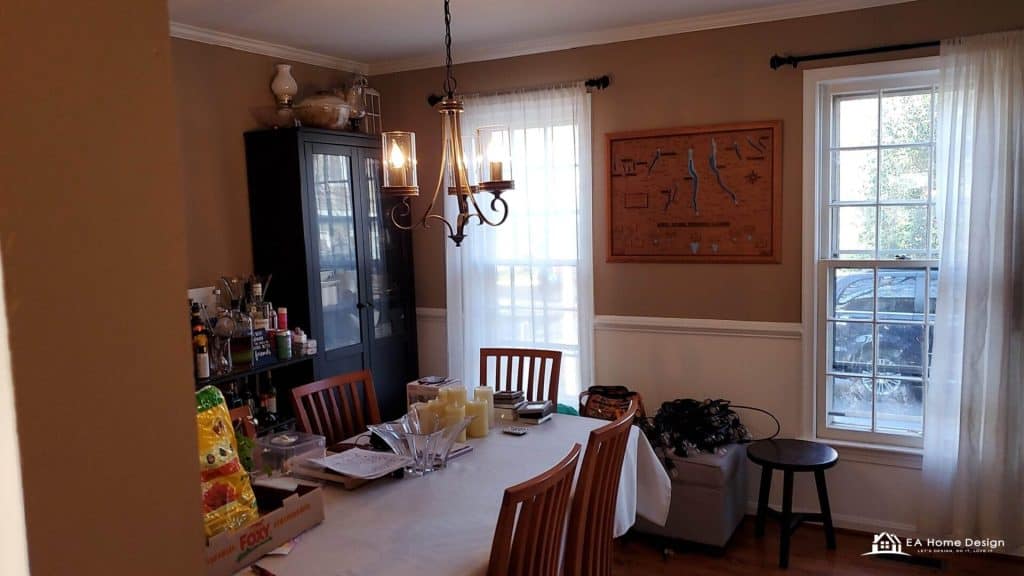Colorful kitchen with blue cabinets, black appliances, and cluttered countertops in a cozy home setting.