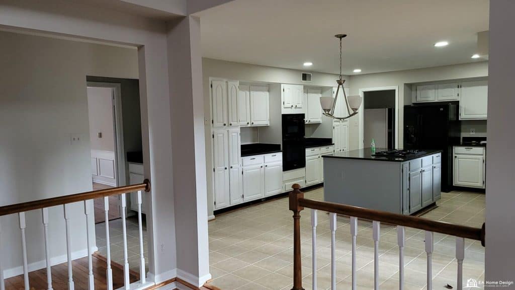 Modern white kitchen with black countertops and central island, ideal for contemporary home design.