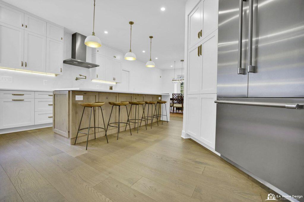 Modern white and wood kitchen with stainless steel appliances and island, bright and open design.