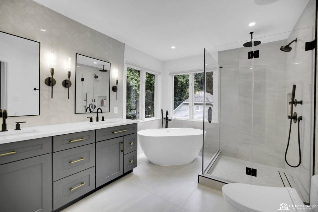 Renovated contemporary bathroom showcasing premium vanity with integrated sink, polished cabinets, oversized mirrors, and sophisticated finishes for a spa-like ambiance.