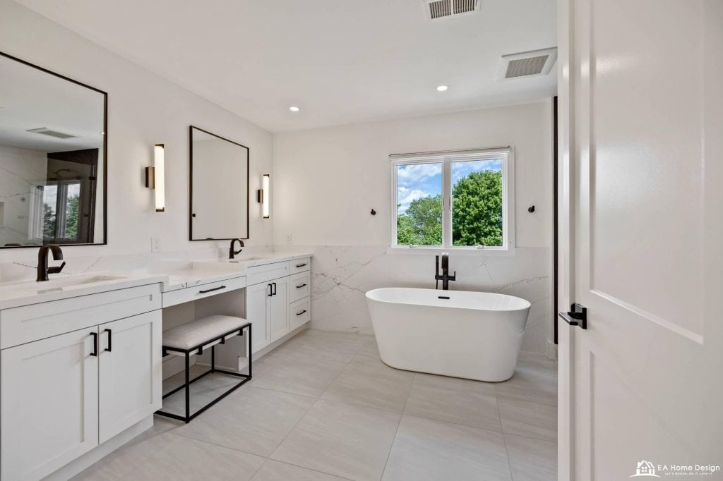 Renovated contemporary bathroom featuring high-end cabinets, a marble countertop vanity, oversized mirrors, and polished fixtures for a stylish, spa-like atmosphere.