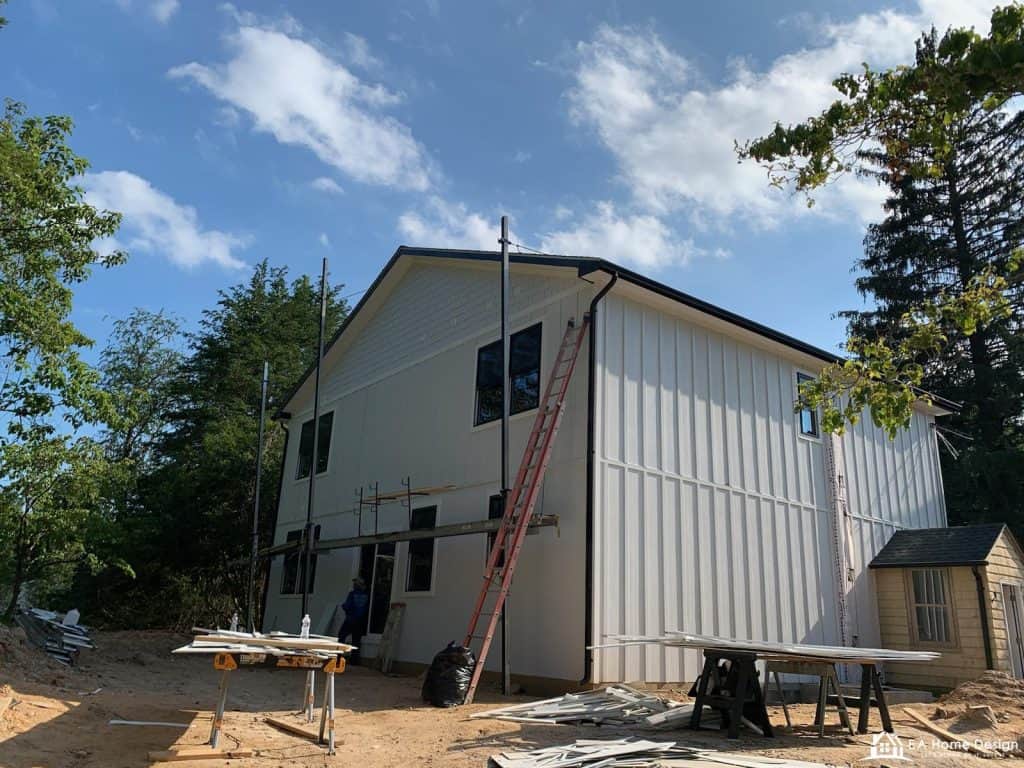 Rooftop view of residential neighborhood with trees and parked cars.