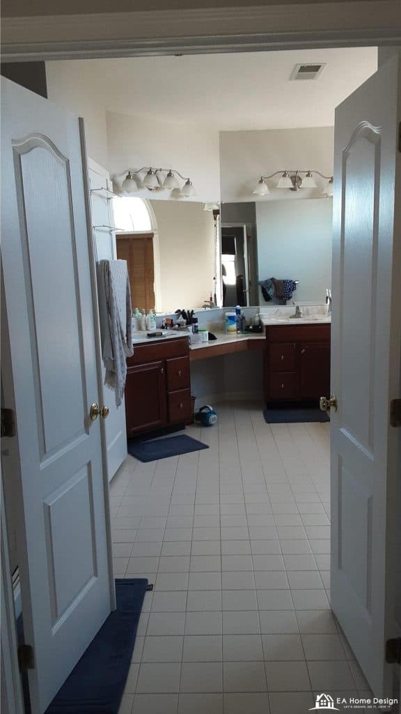 Modern marble bathroom with tub, shower, toilet, and gold accents.