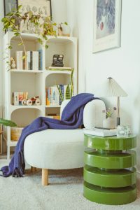 A cozy reading nook features a plush chair and leafy plants, highlighting clever closet conversions.