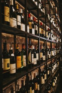 Clever Closet Conversions: shelves repurposed to neatly display wine bottles in a once-unused space.