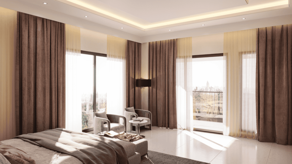 A modern bedroom with large windows covered by beige and brown curtains, a cozy bed, two armchairs with a small table, and recessed ceiling lighting. Sunlight streams in, perfect inspiration for home improvement in Fairfax County, VA.