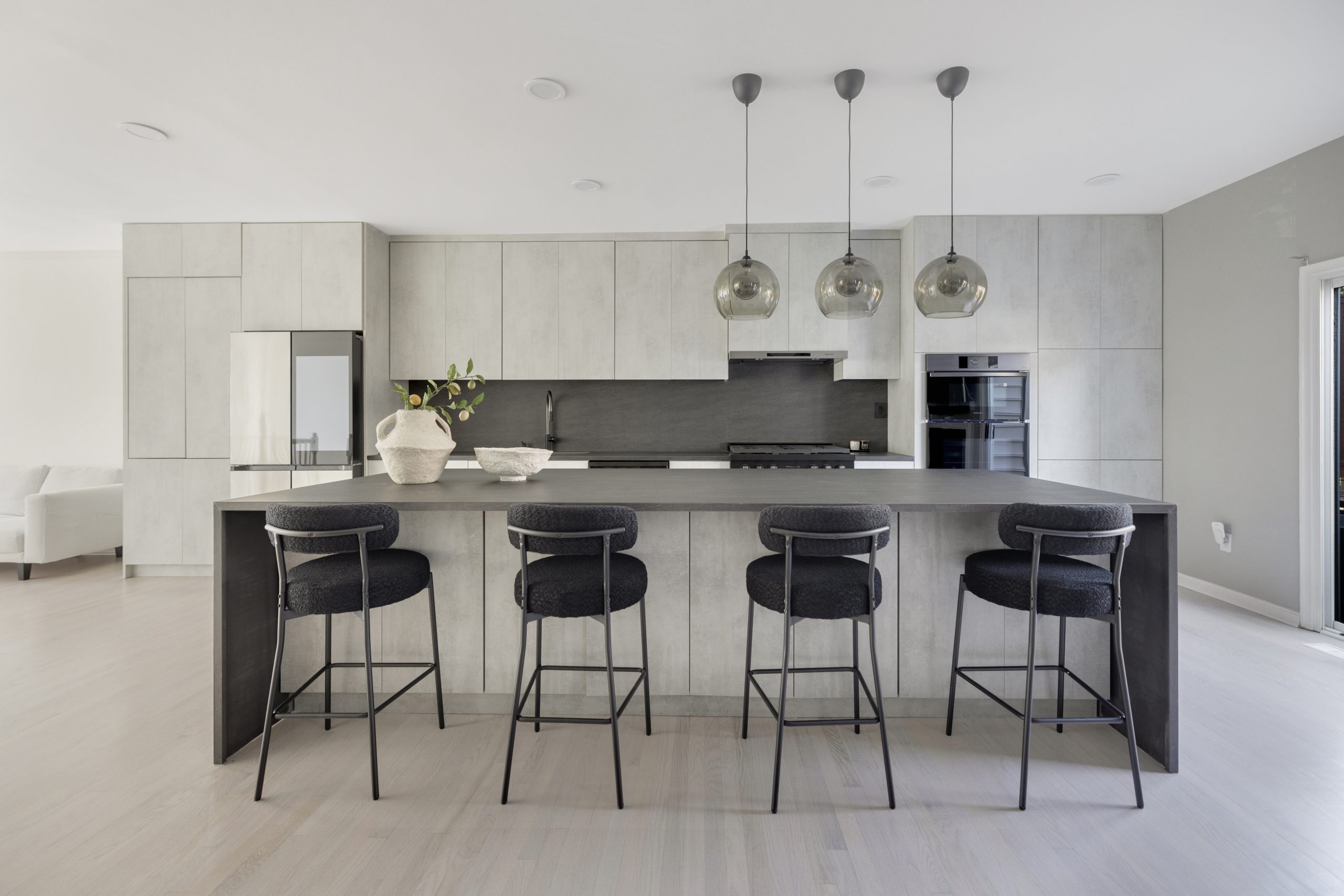 Contemporary minimalist kitchen with island, pendant lighting, and sleek cabinetry for modern home design.