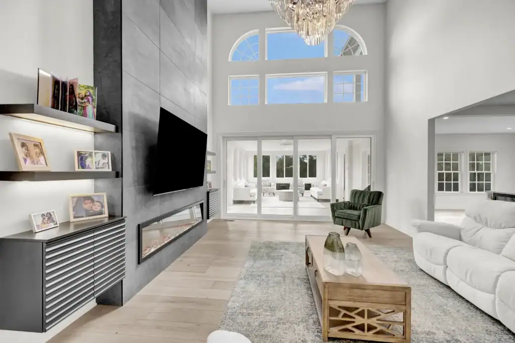 After: the two storey family room with the new fireplace wall and floating shelves