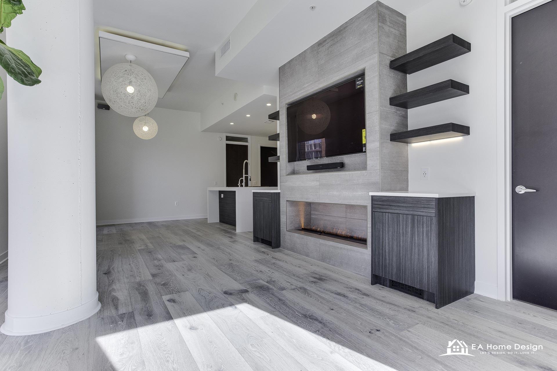 Interior design project in Northern Virginia with grey tile media wall, linear fireplace, floating shelves and wide plank light floors
