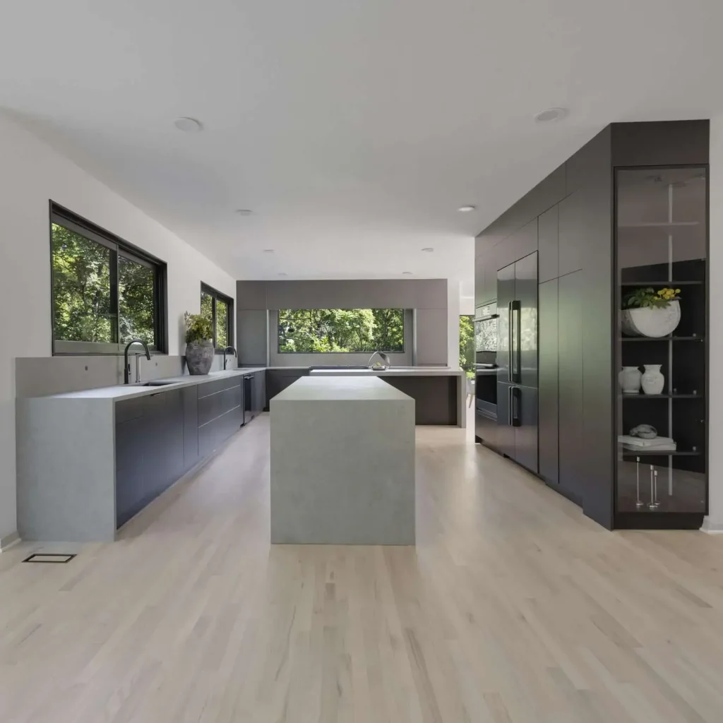 Contemporary minimalist kitchen with sleek cabinetry and natural light from large windows.