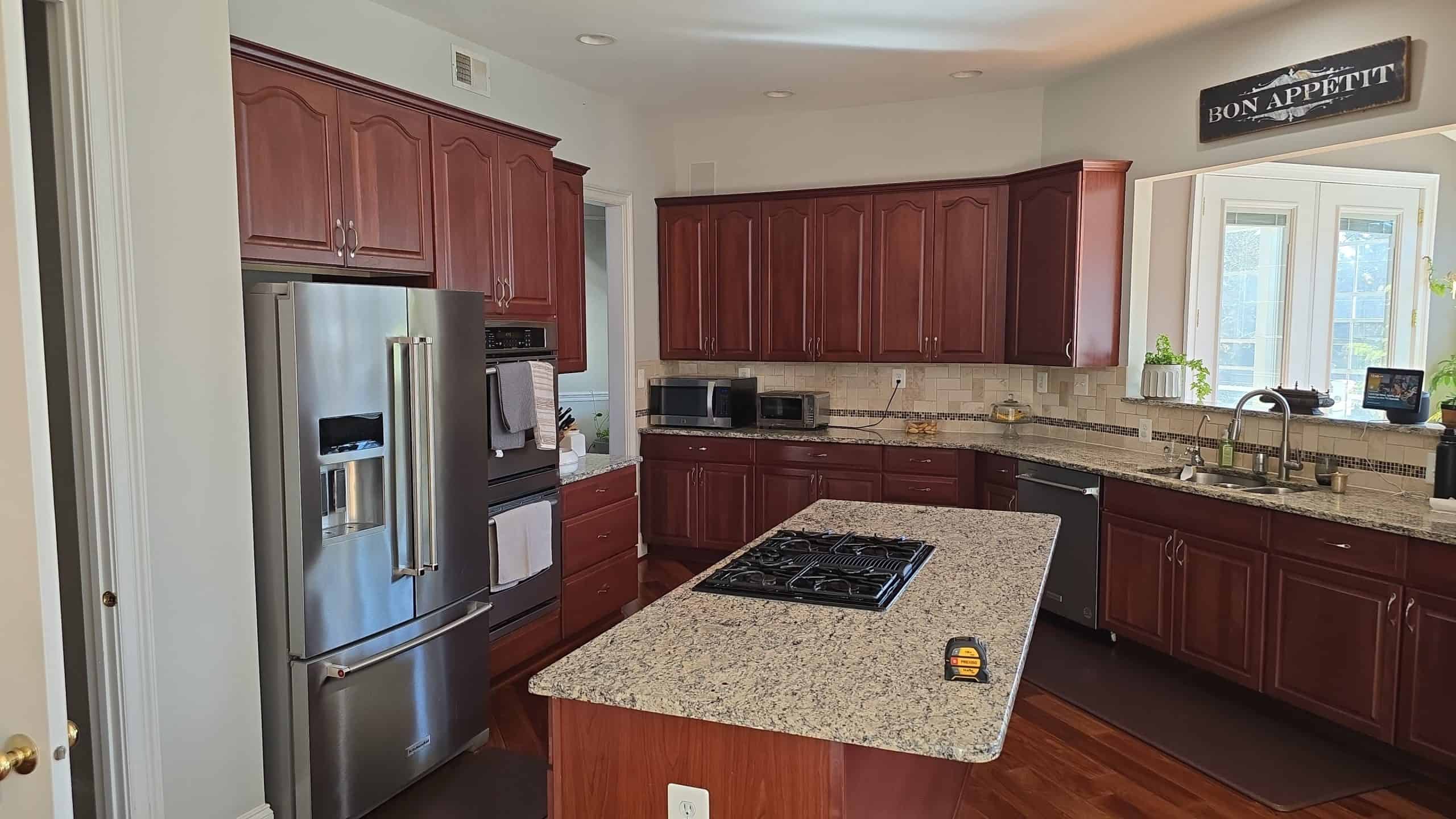Elegant kitchen with polished granite countertops, stainless steel appliances, and custom wood cabinetry, creating a stylish and functional cooking space.