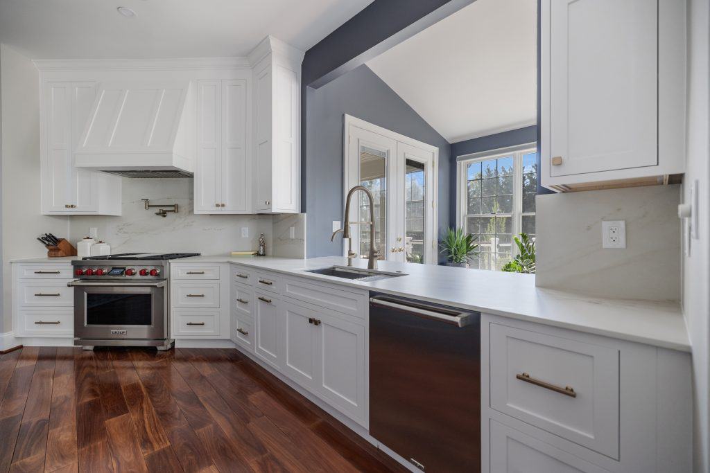Bright modern kitchen with white cabinetry and stainless steel appliances for stylish home design