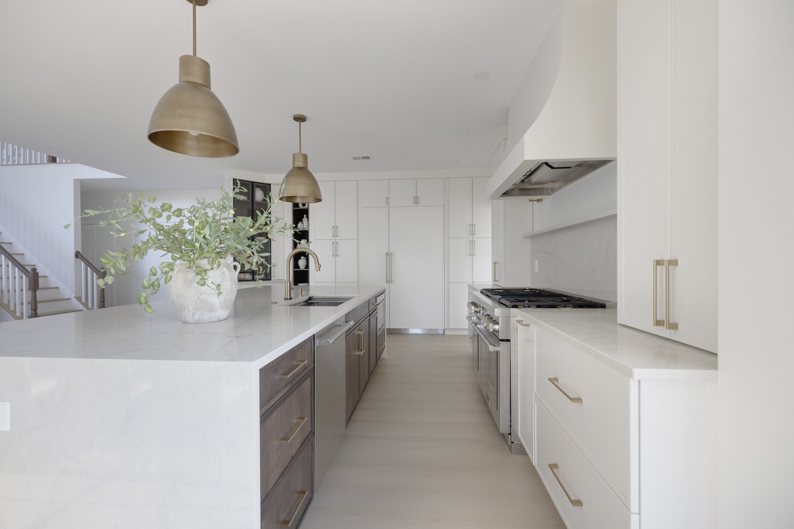 A kitchen with white cabinets and white appliances.