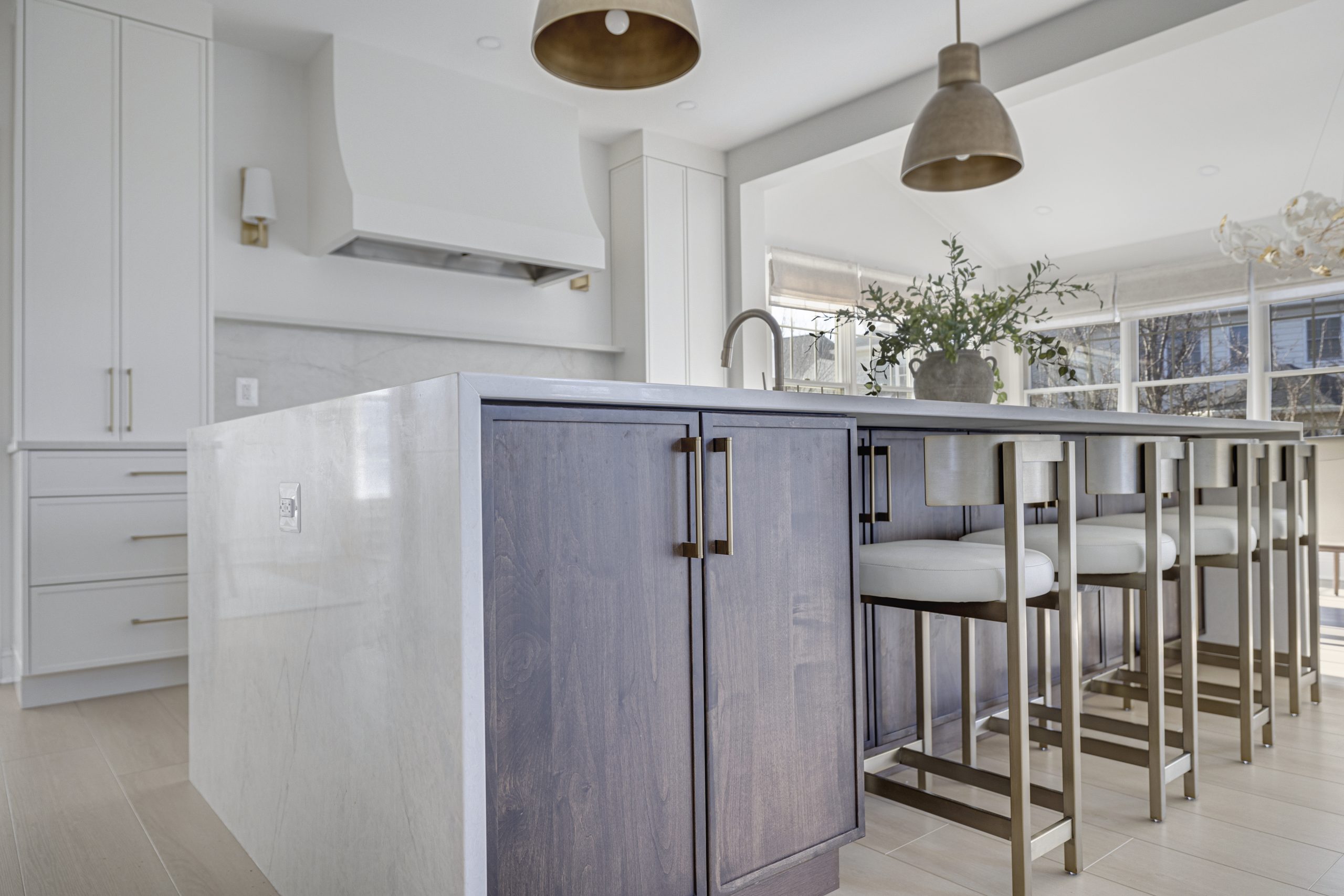 Transitional kitchen in Northern Virginia with marble island, warm wood cabinets, and gold hardware