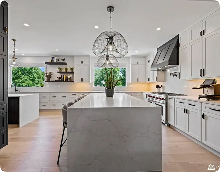Modern kitchen with white cabinets, marble island, black accents, light wood flooring, large windows, built-in appliances, open shelving, and a central plant under a unique wire pendant light fixture.