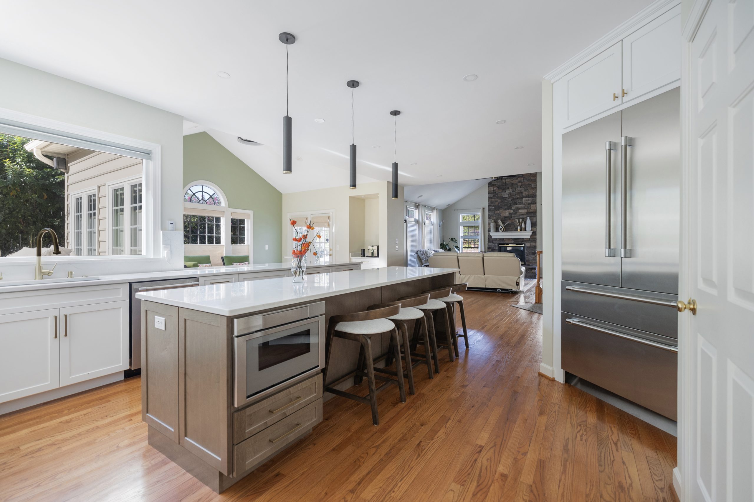 Open concept kitchen cabinet design with large island and bar seating in Fairfax County