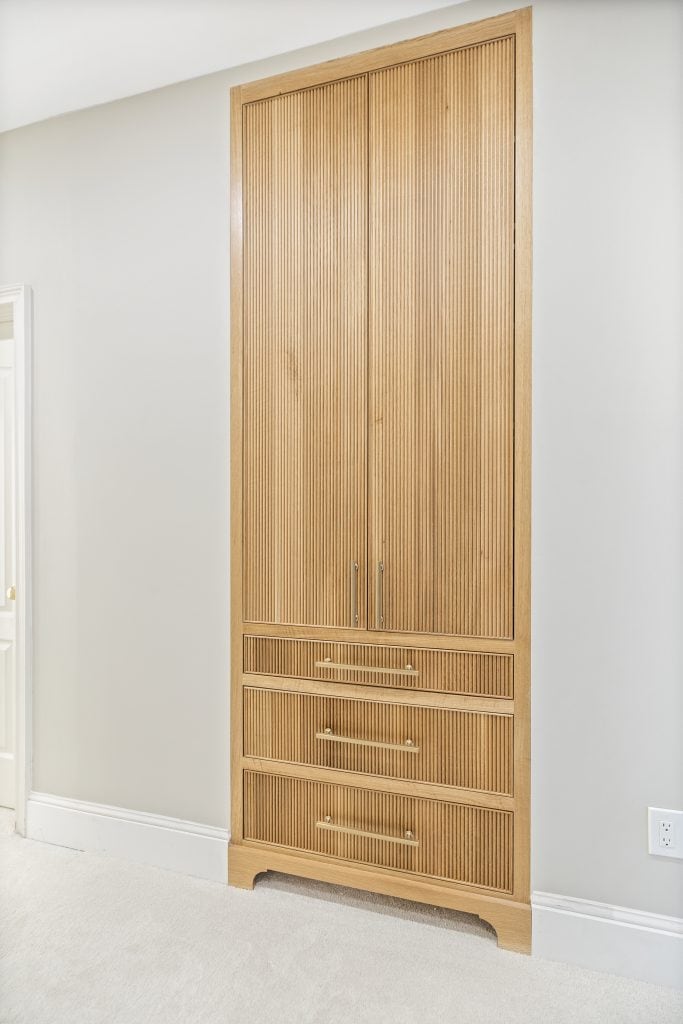 After: matching reeded oak storage cabinet carried into the hallway