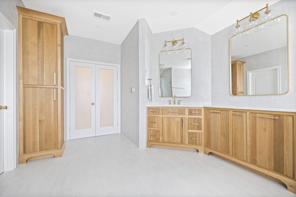 After: tall reeded oak linen cabinet, frosted double doors and the second vanity