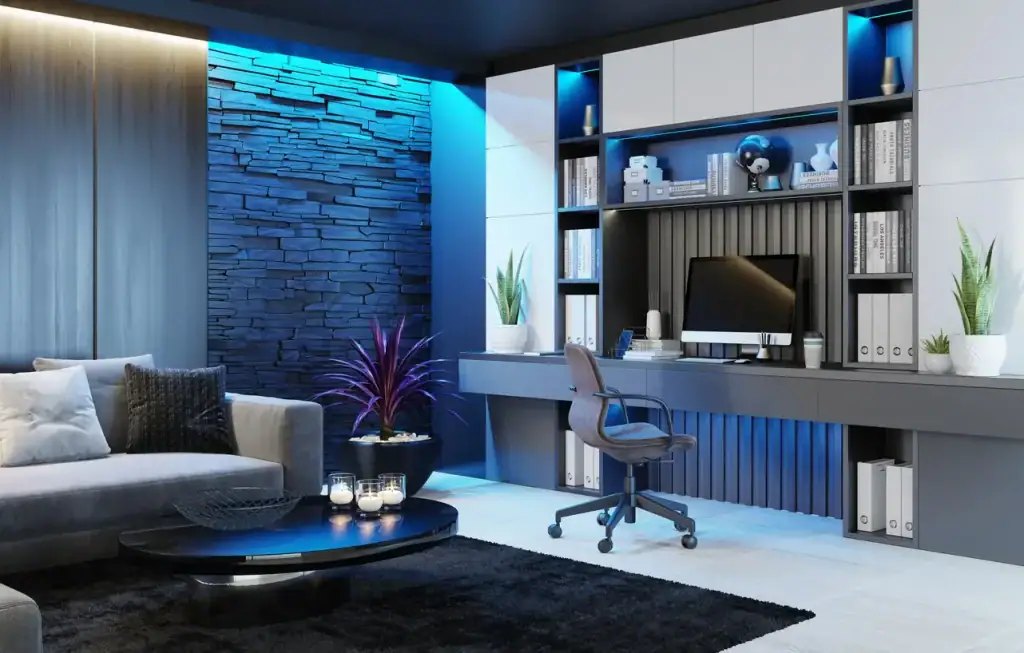 Modern home office features a desk, computer, shelves, plants, gray sofa, and blue accent lighting.