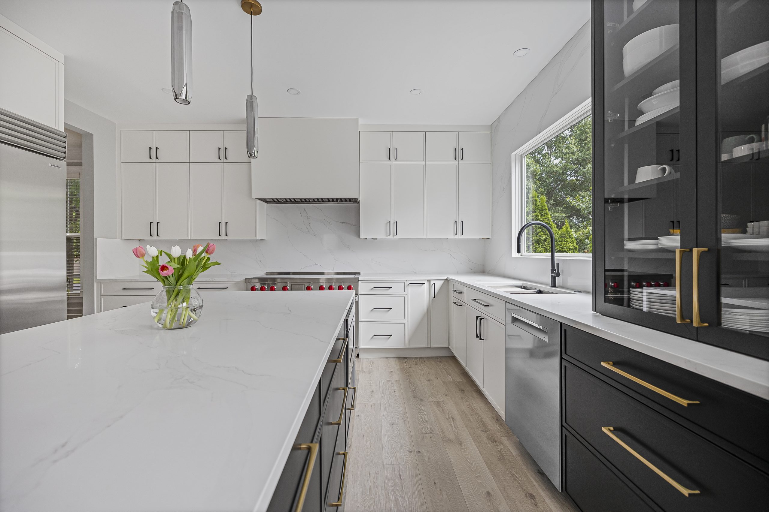 Modern white kitchen with black island designed by a Northern Virginia design build firm