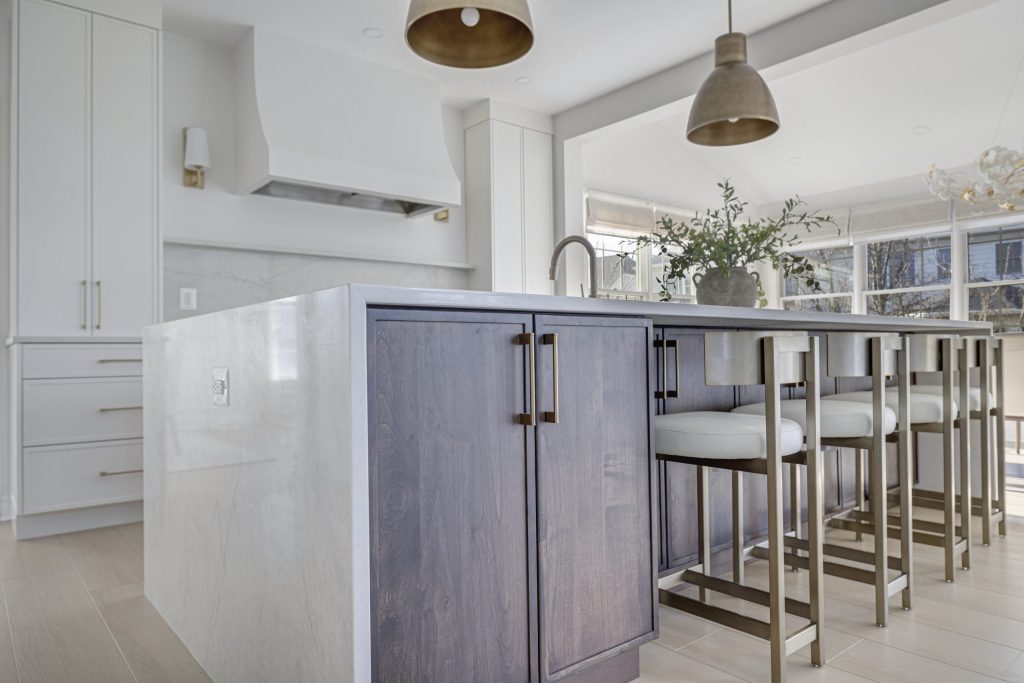Transitional kitchen with marble island and warm wood cabinetry in Northern Virginia